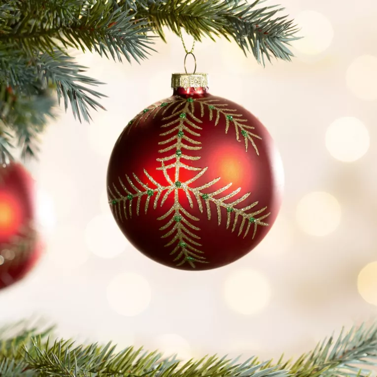 Bombka choinkowa ręcznie zdobiona brokatowym motywem gałązek