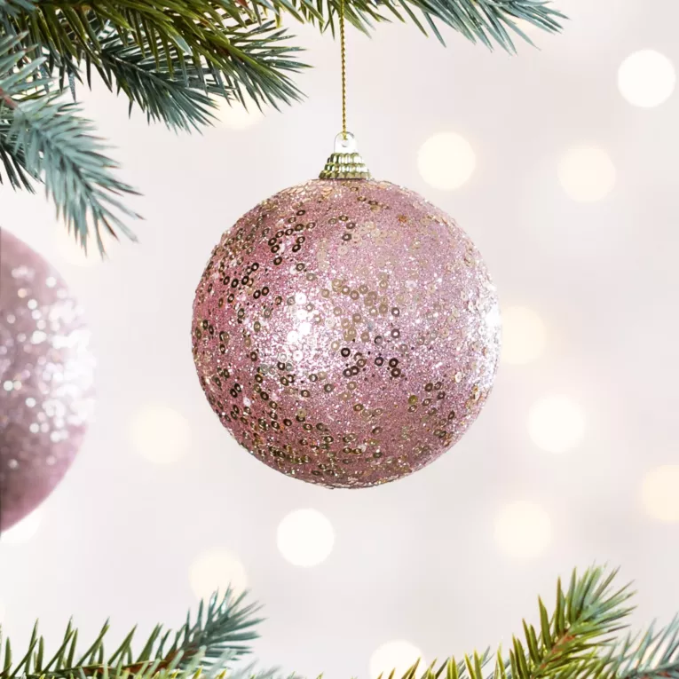Bombka choinkowa obsypana lśniącym brokatem i cekinami