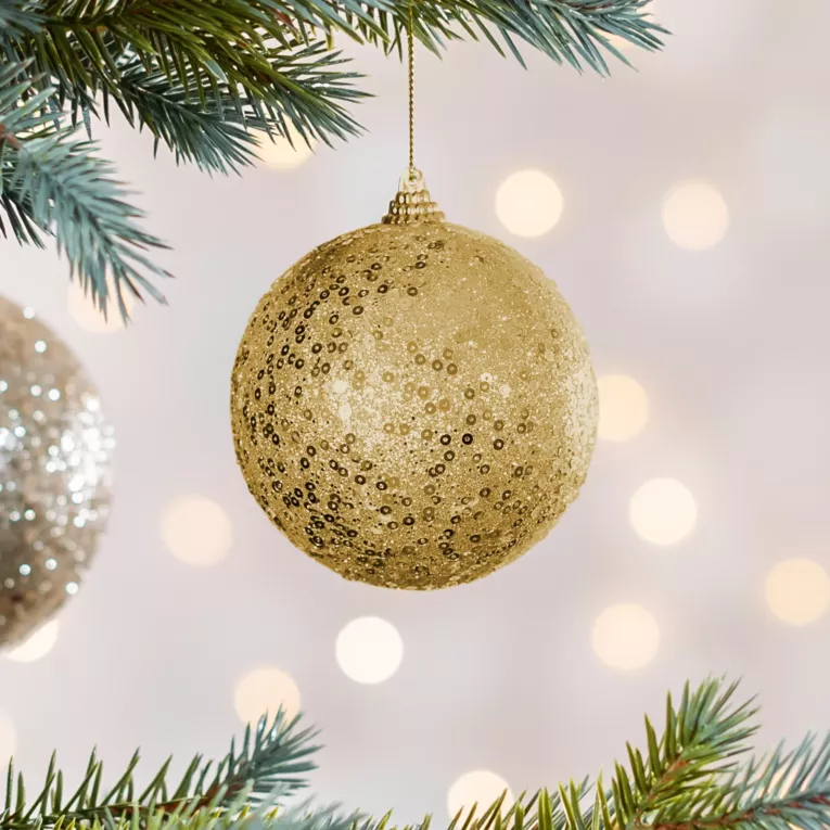 Bombka choinkowa obsypana lśniącym brokatem i cekinami