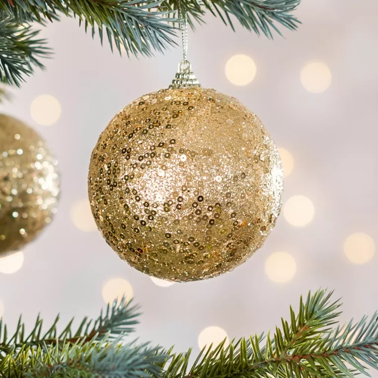 Bombka choinkowa obsypana lśniącym brokatem i cekinami