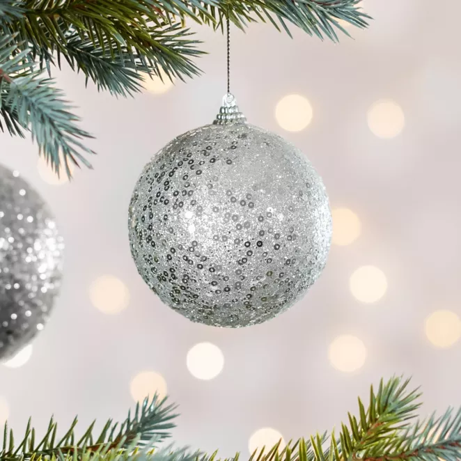 Bombka choinkowa obsypana lśniącym brokatem i cekinami
