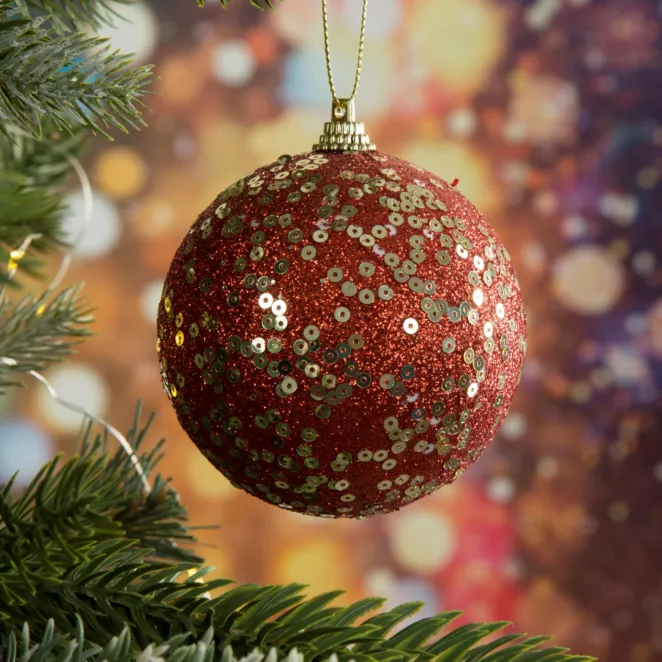 Bombka choinkowa obsypana lśniącym brokatem i cekinami