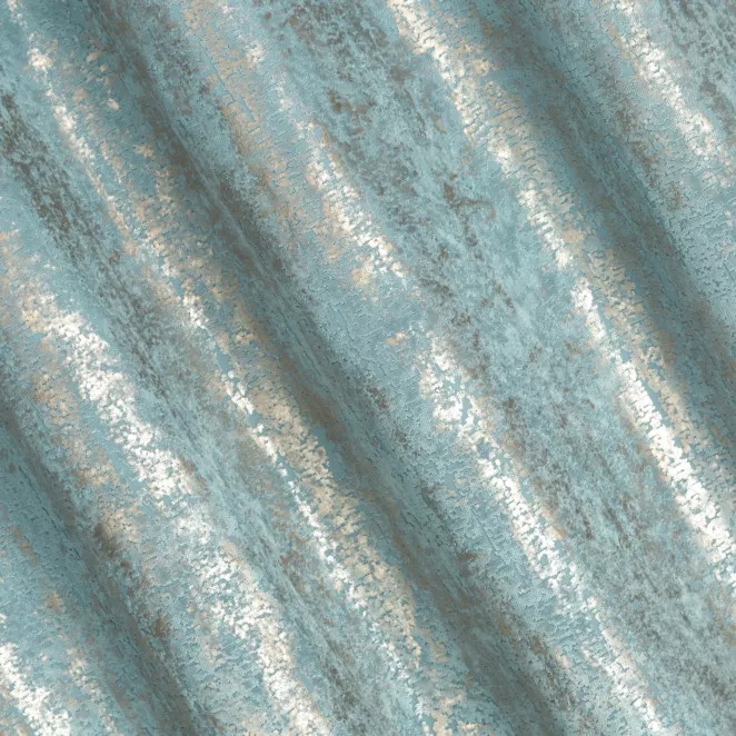 R185/3 Zasłona szyta na taśmie 5 cm niebiesko złocista z grubej, welwetowej tkaniny z efektem przecieranego wzoru, zdobiona delikatnie połyskującym nadrukiem