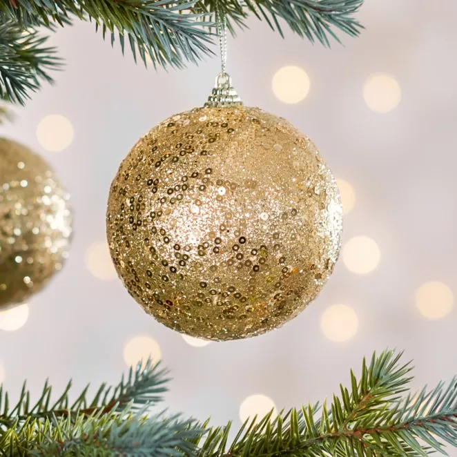 Bombka choinkowa obsypana lśniącym brokatem i cekinami