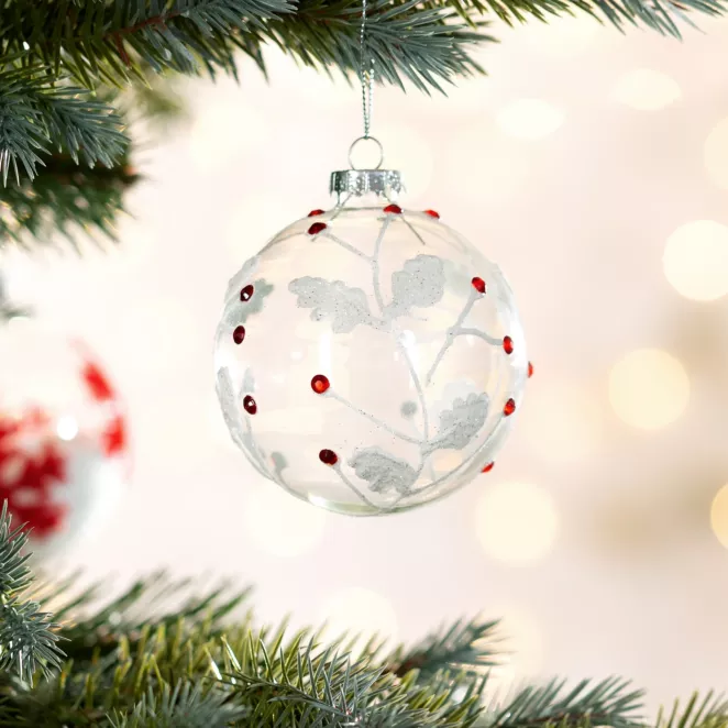 Bombka szklana transparentna z motywem białych gałązek dekorowanych czerwonymi kryształkami